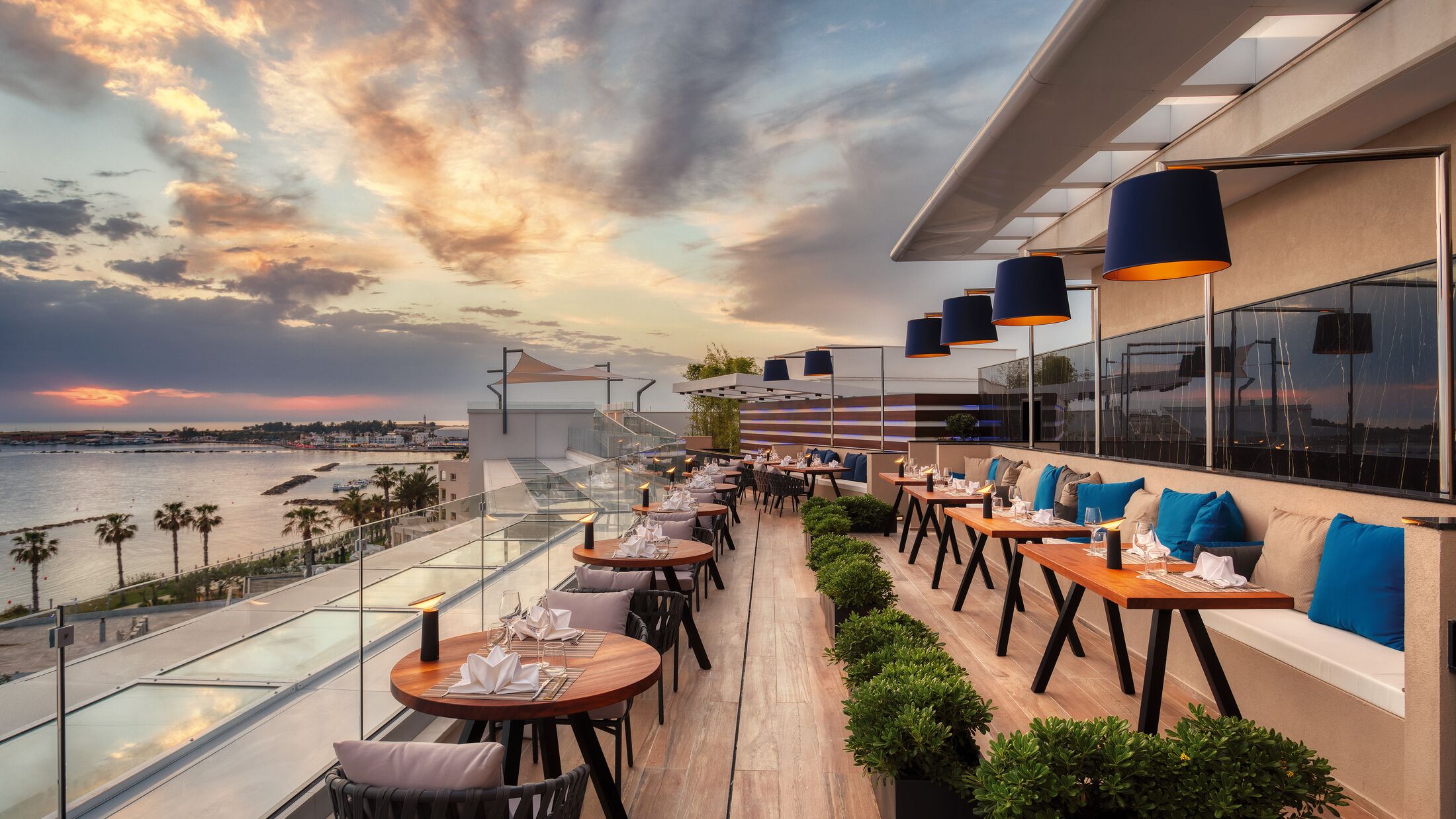 a row of wooden benches sitting on top of a body of water