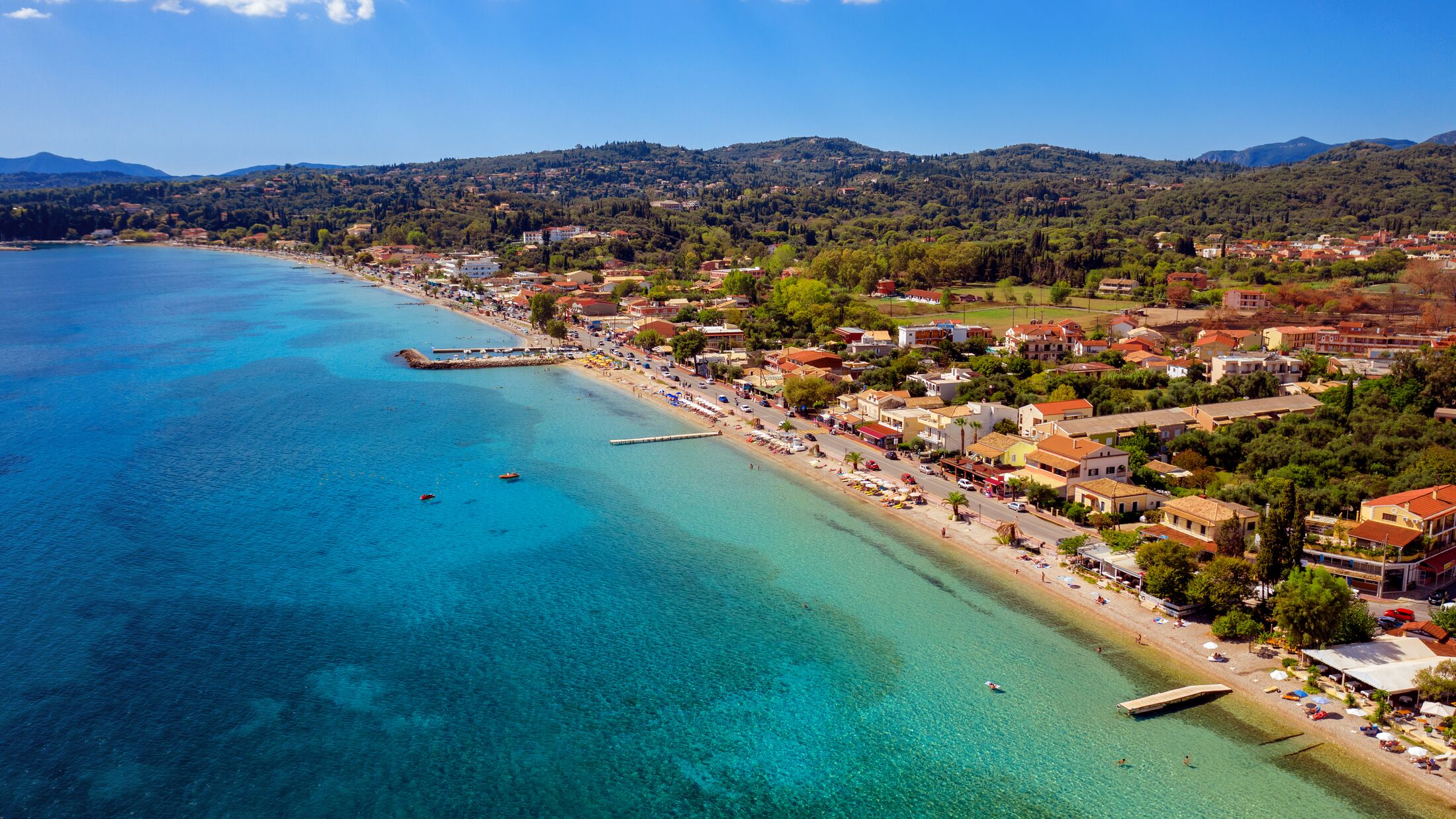 Beautiful long mediterranean beach in Greece aerial. A greek resort on Corfu island.
