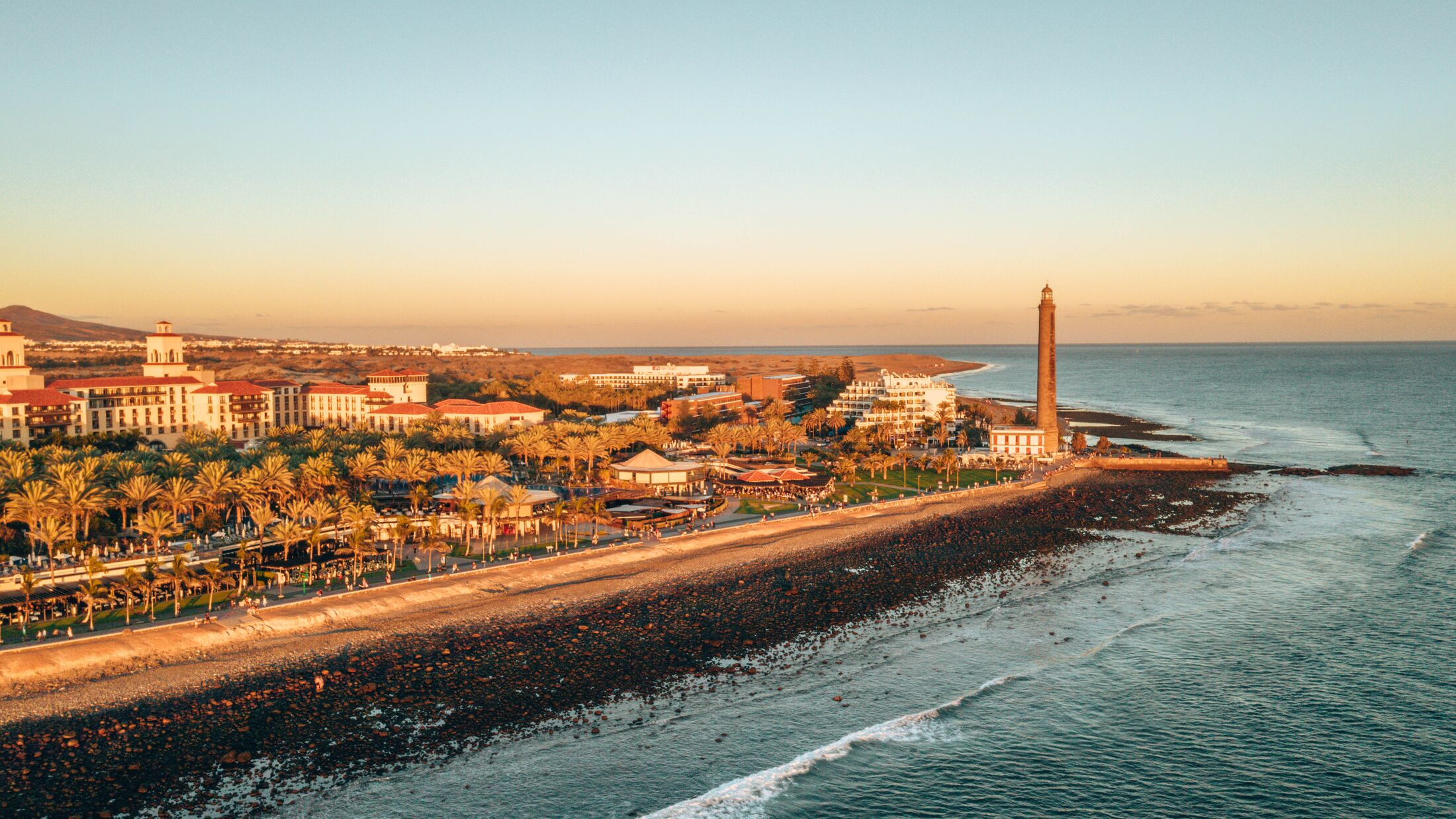 Aerial lighthouse view in Meloneras area on Gran Canaria island during magical sunset.
