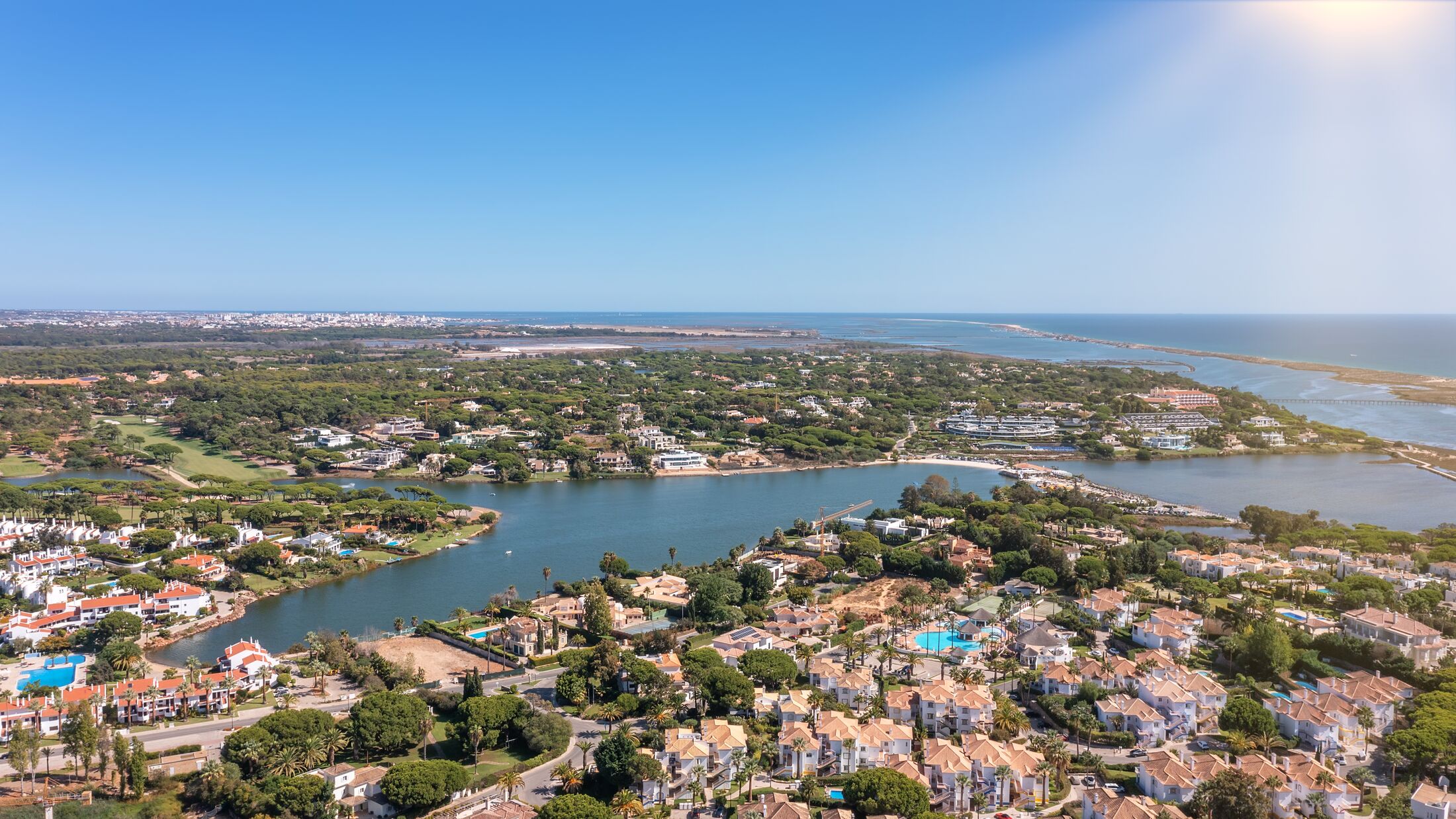 Aerial overview of luxury villas located around Quinta do Lago, Algarve, Portugal, Europe. Drone shot in the green zone.